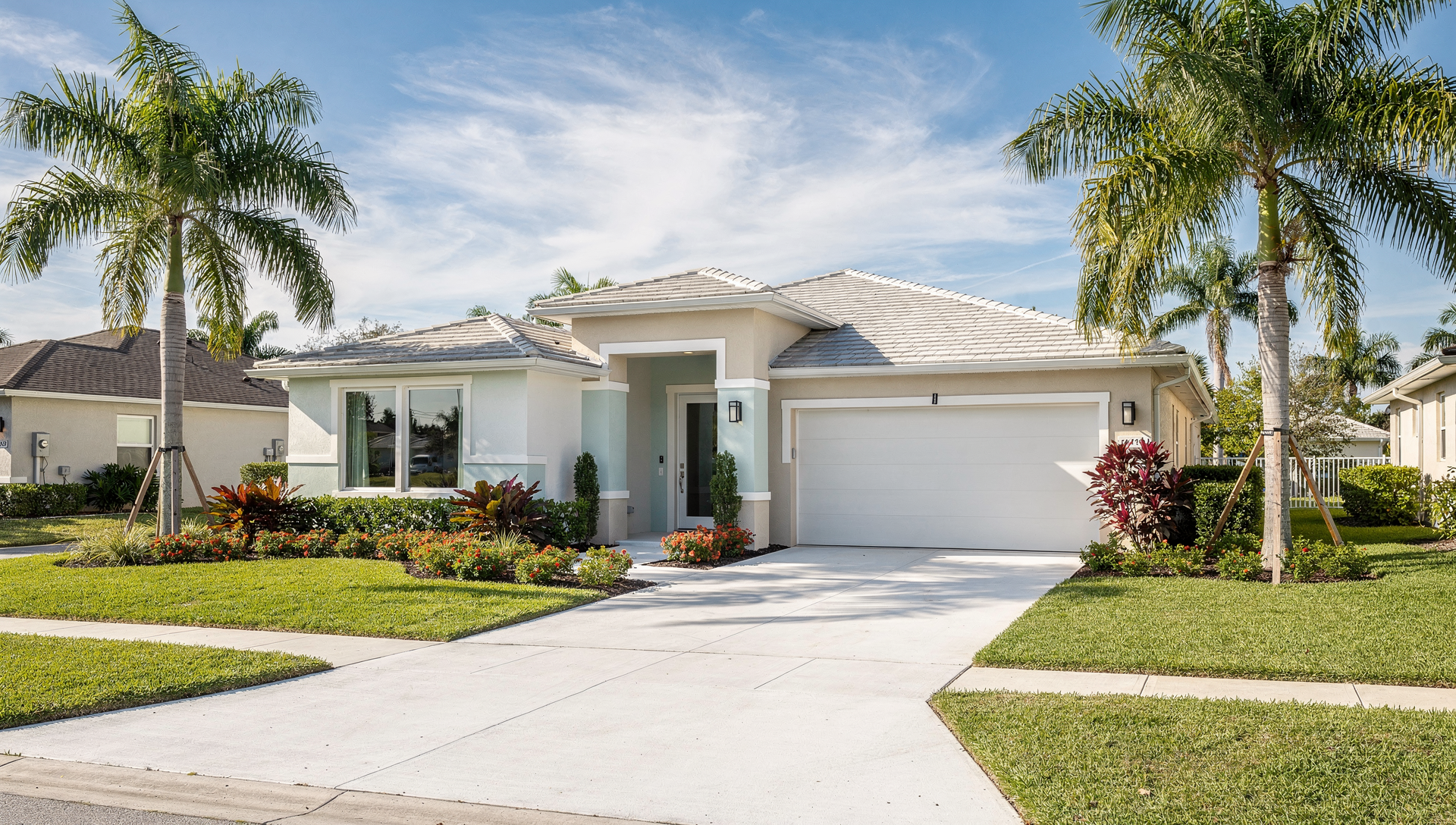 Energy efficient Florida home exterior with modern windows and palm trees